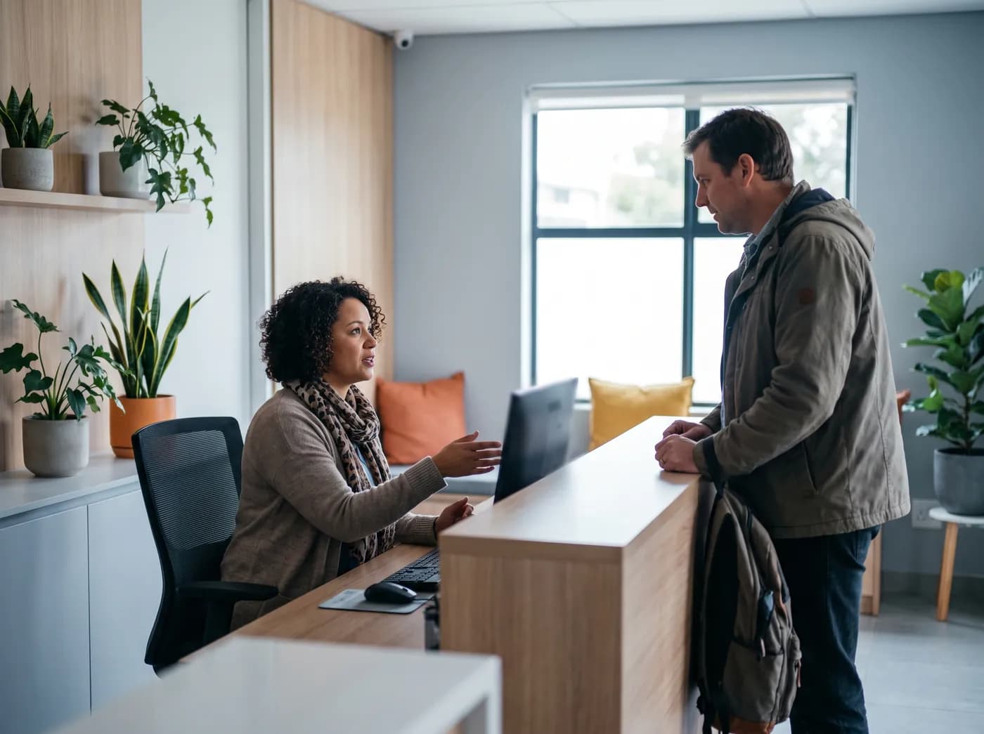 A receptionist booking a patient at a medical practice front desk